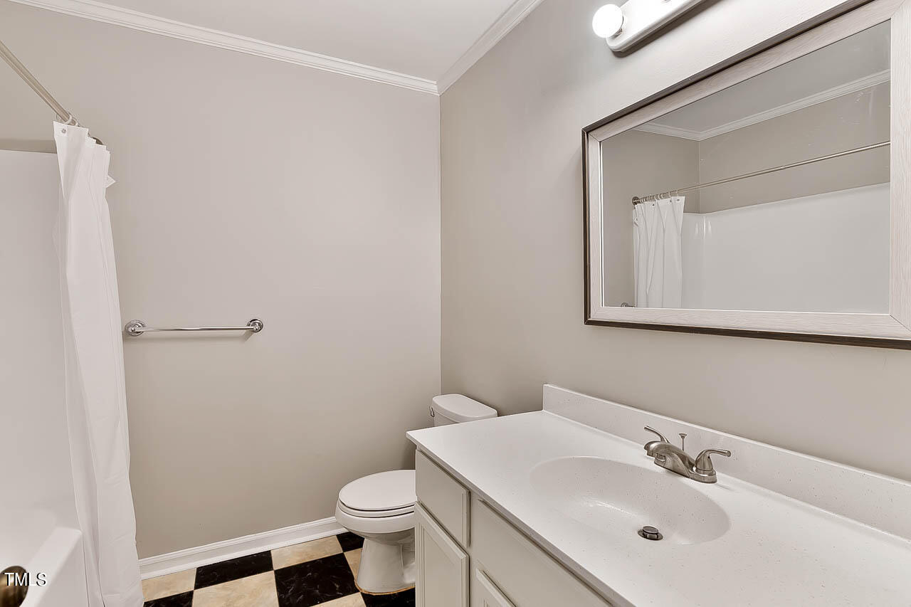 5525 Middleton Road Durham, NC 27713 - Photo 37 of 38 a bathroom with a sink a toilet and mirror