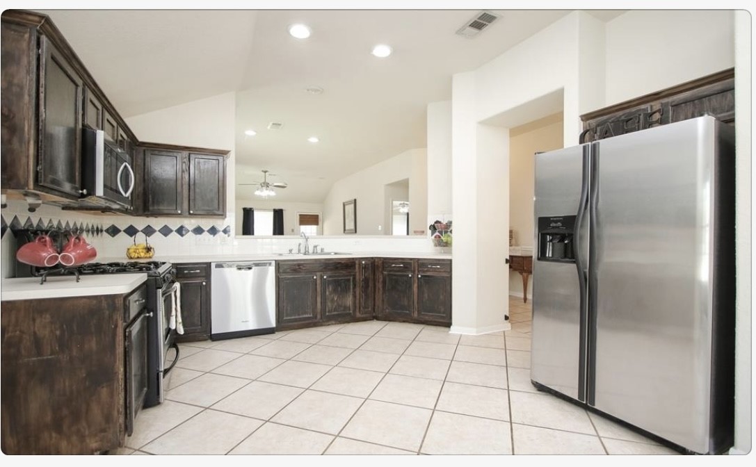 12006 Cyprus Field Houston, TX 77070 - Photo 3 of 7 a kitchen with stainless steel appliances a refrigerator sink and cabinets
