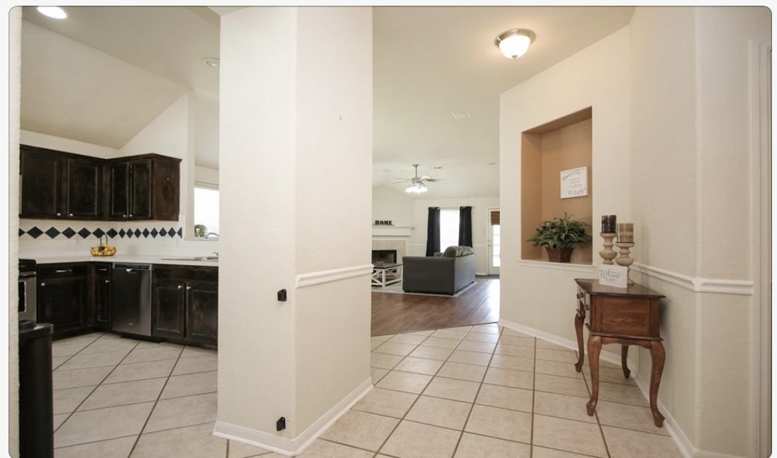 12006 Cyprus Field Houston, TX 77070 - Photo 7 of 7 a living room with furniture a flat screen tv and kitchen view