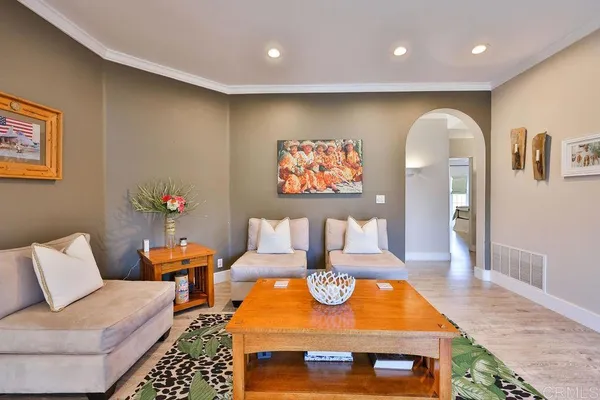 a view of living room kitchen with stainless steel appliances granite countertop furniture and a fireplace