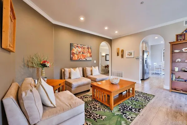 a kitchen that has a lot of cabinets in it and wooden floors