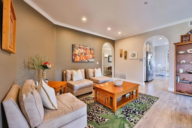 a kitchen that has a lot of cabinets in it and wooden floors