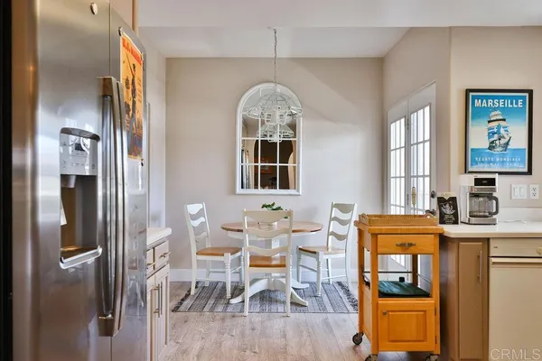 a view of a dining room with furniture wooden floor and a chandelier
