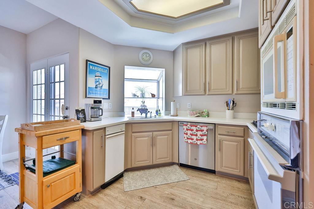 229 Orange, Unit 3 Coronado, CA 92118 - Photo 22 of 68 a kitchen with granite countertop cabinets stainless steel appliances a sink and a window