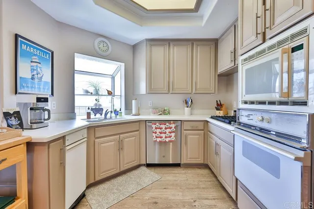 a metallic refrigerator freezer sitting in a kitchen