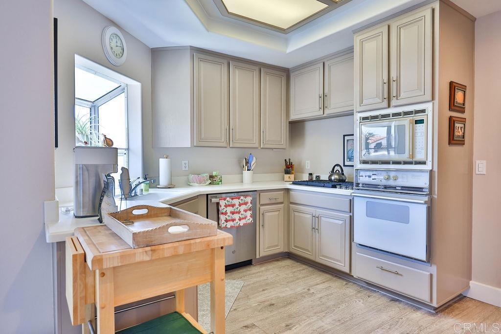 229 Orange, Unit 3 Coronado, CA 92118 - Photo 25 of 68 a kitchen with a stove sink and cabinets