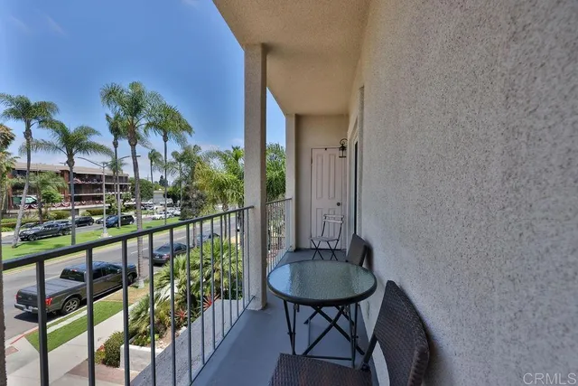 a view of a couches with potted plants in front of main door