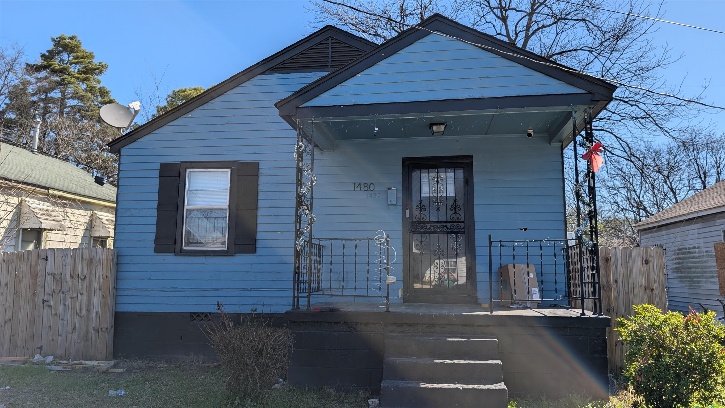 1480 Locust Street Memphis, TN 38108 - Photo 1 of 7 a front view of a house with a yard