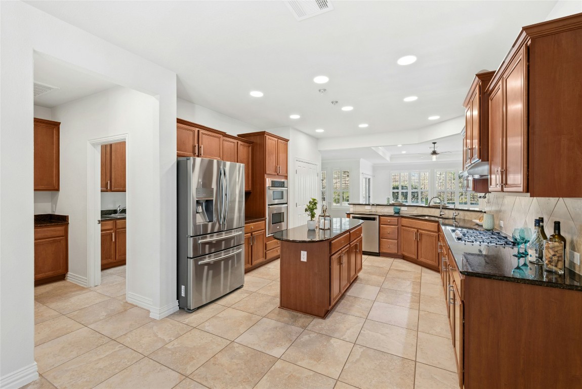 310 Pipe Creek Lane Georgetown, TX 78633 - Photo 11 of 35 a kitchen with stainless steel appliances a refrigerator and a stove top oven