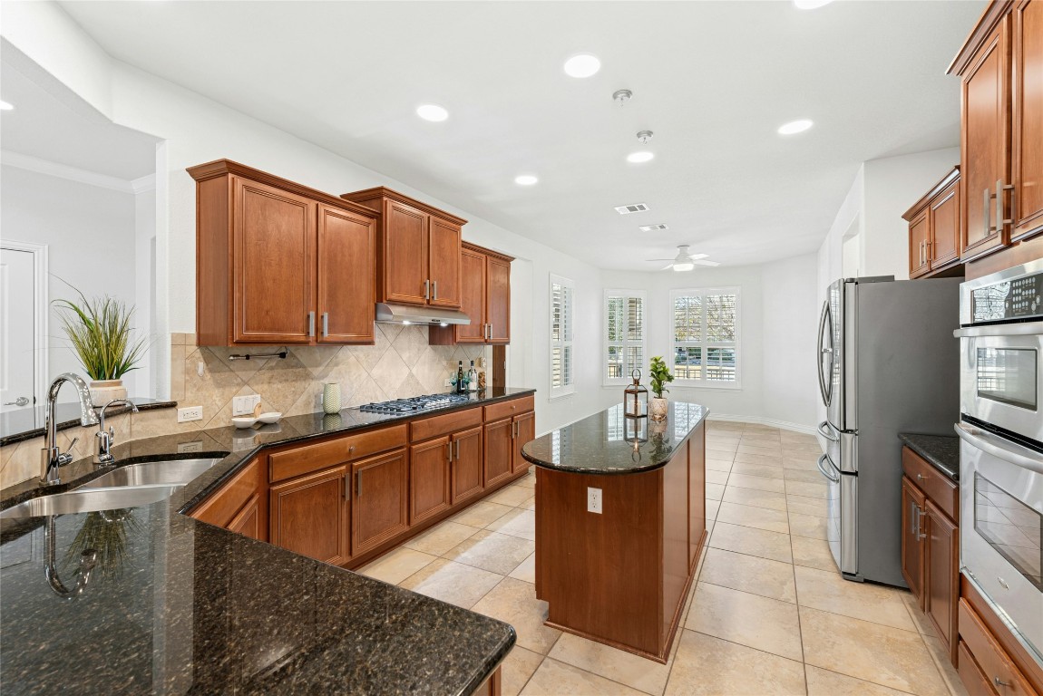 310 Pipe Creek Lane Georgetown, TX 78633 - Photo 13 of 35 a kitchen with stainless steel appliances granite countertop a sink a stove and a refrigerator