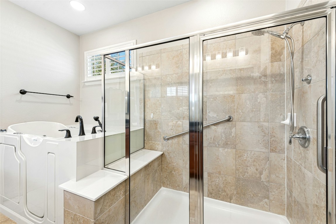 310 Pipe Creek Lane Georgetown, TX 78633 - Photo 19 of 35 a bathroom with a bathtub and a shower