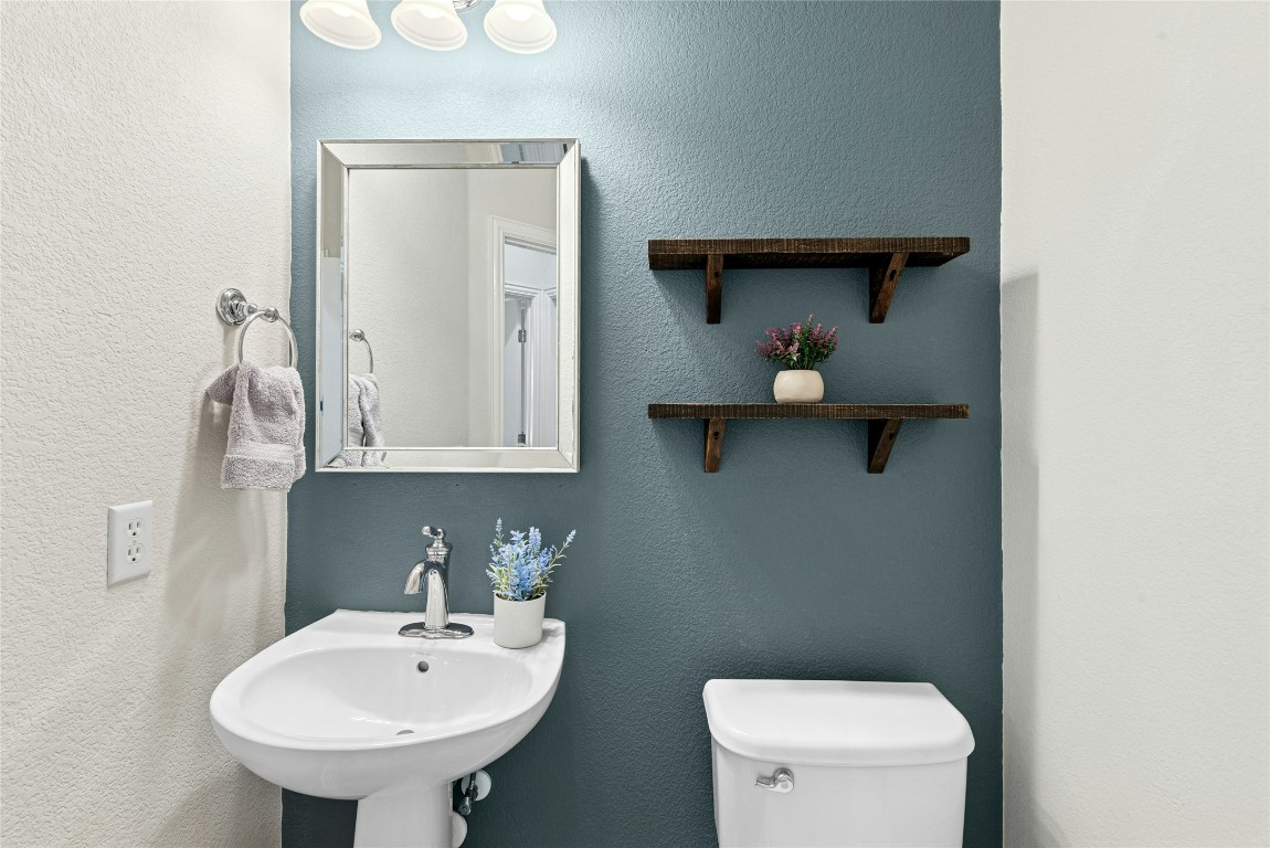 310 Pipe Creek Lane Georgetown, TX 78633 - Photo 26 of 35 a bathroom with a toilet a sink and mirror