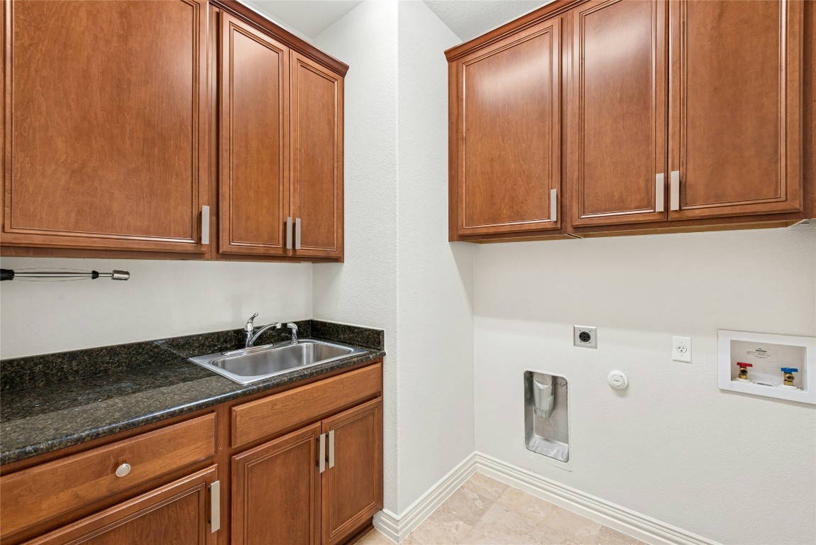 310 Pipe Creek Lane Georgetown, TX 78633 - Photo 27 of 35 a kitchen with granite countertop cabinets and sink