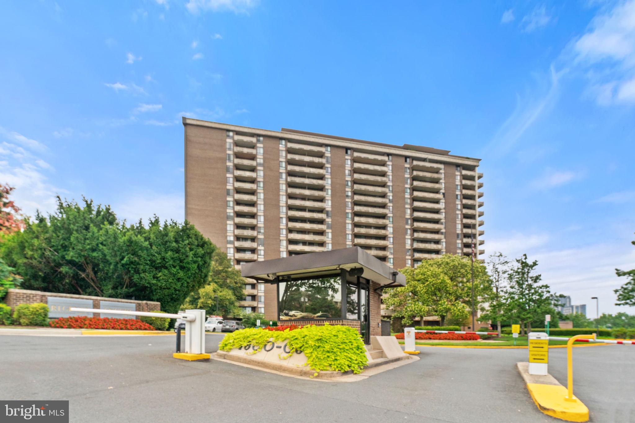 a view of building with swimming pool and patio