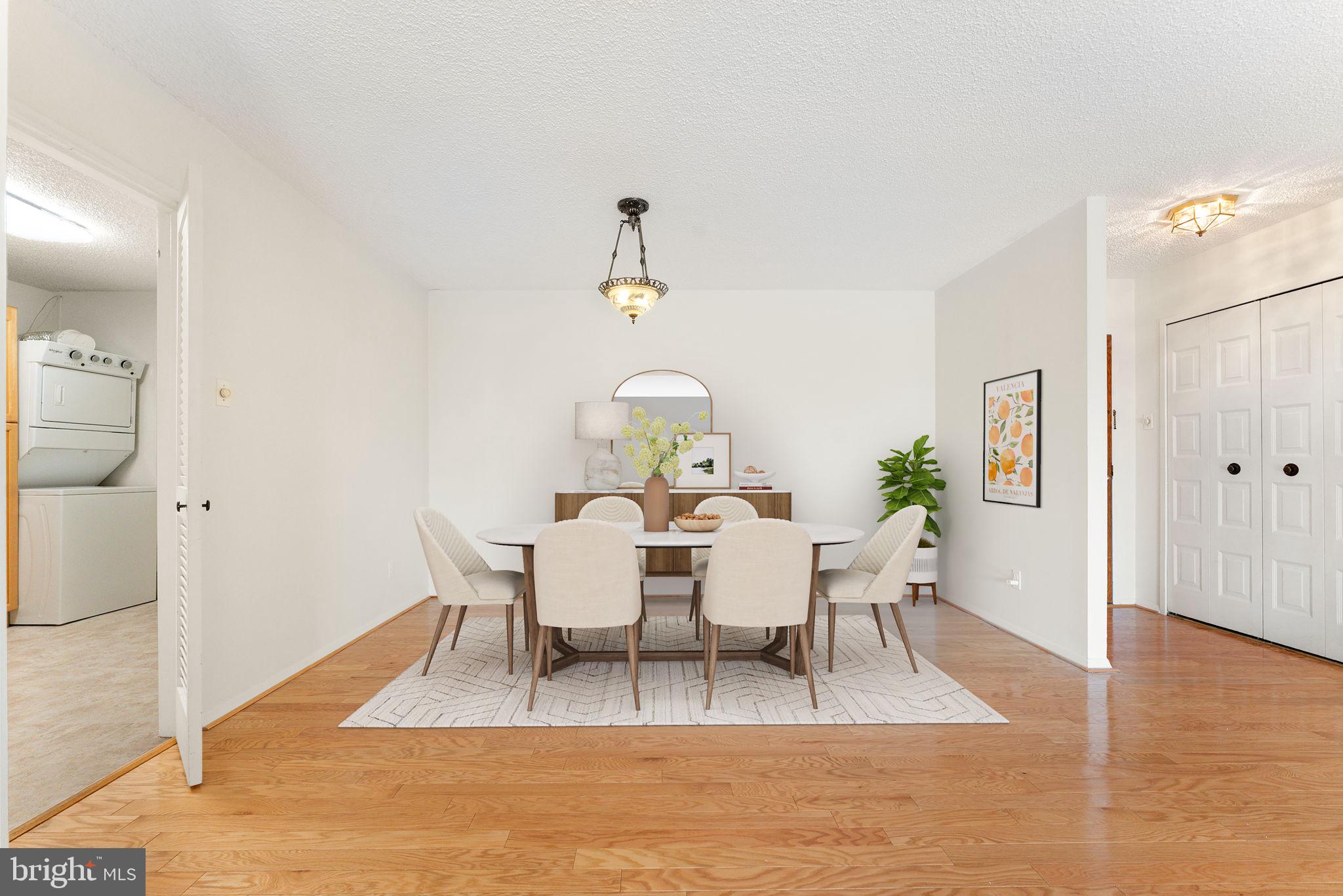 1800 Old Meadow Road, Unit 1218 McLean, VA 22102 - Photo 18 of 55 a view of a dining room with furniture and wooden floor
