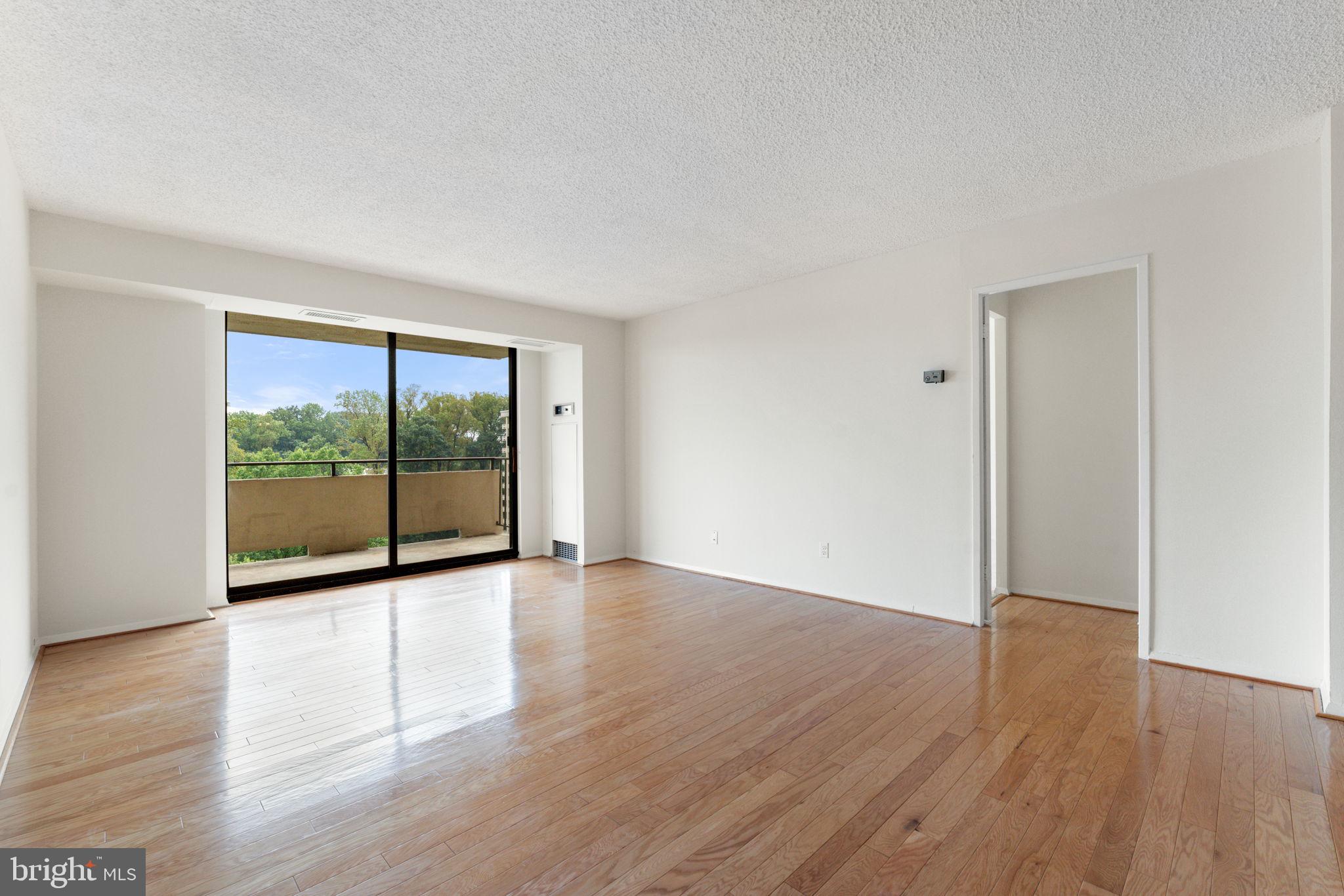 1800 Old Meadow Road, Unit 1218 McLean, VA 22102 - Photo 20 of 55 a view of an empty room with wooden floor and a window
