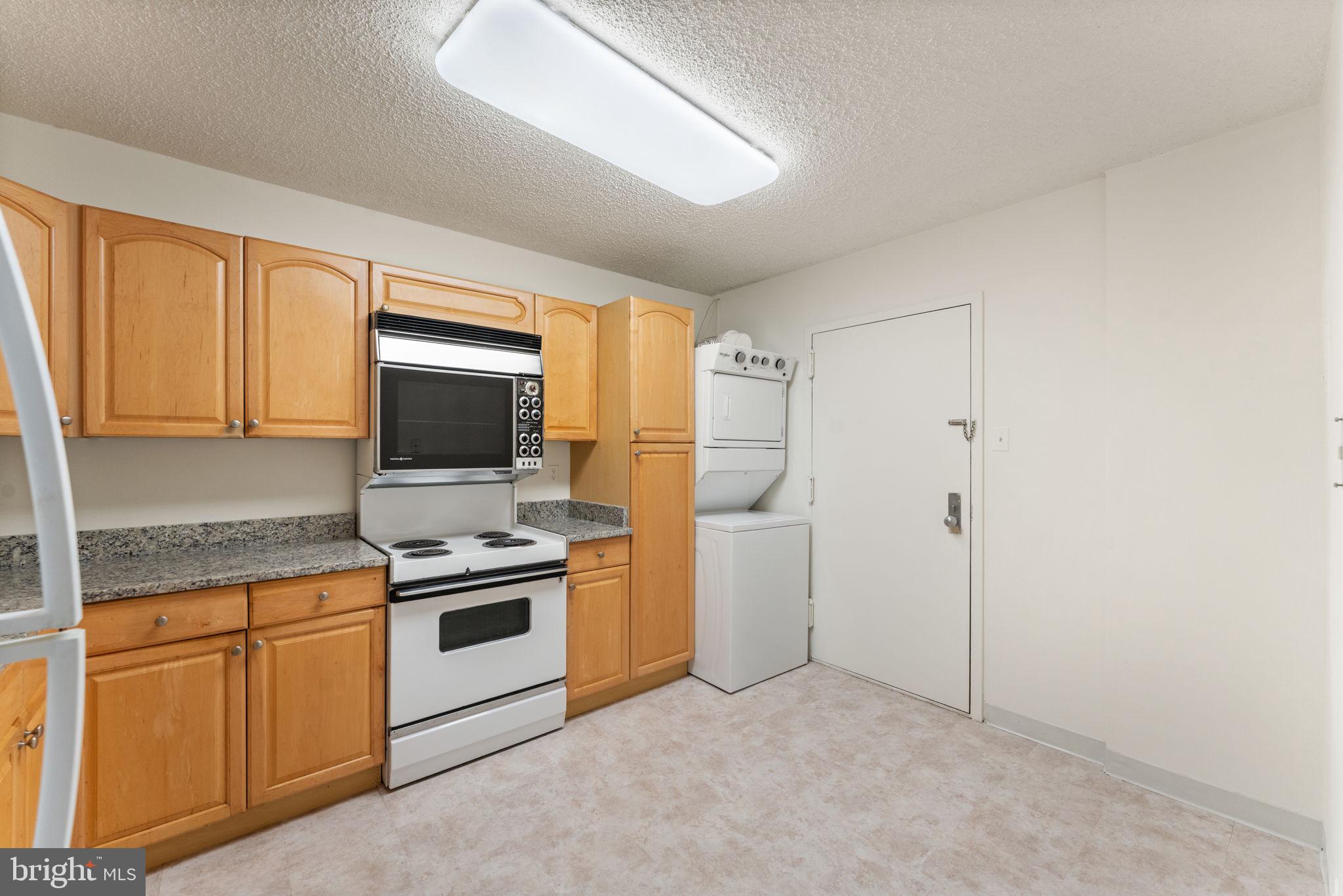 1800 Old Meadow Road, Unit 1218 McLean, VA 22102 - Photo 23 of 55 a kitchen with cabinets and stainless steel appliances
