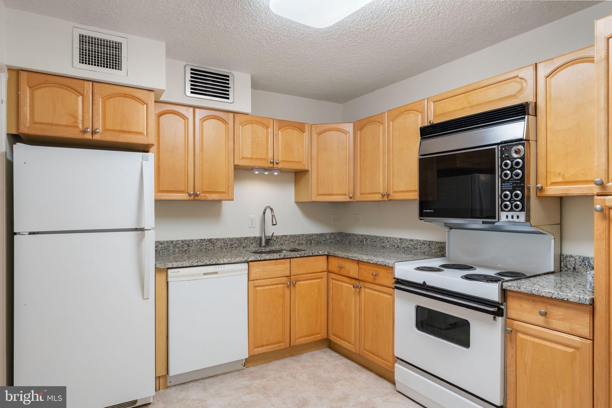 1800 Old Meadow Road, Unit 1218 McLean, VA 22102 - Photo 27 of 55 a kitchen with appliances a sink and cabinets