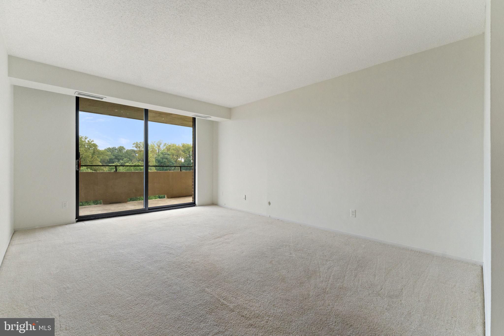 1800 Old Meadow Road, Unit 1218 McLean, VA 22102 - Photo 30 of 55 a view of an empty room with a balcony