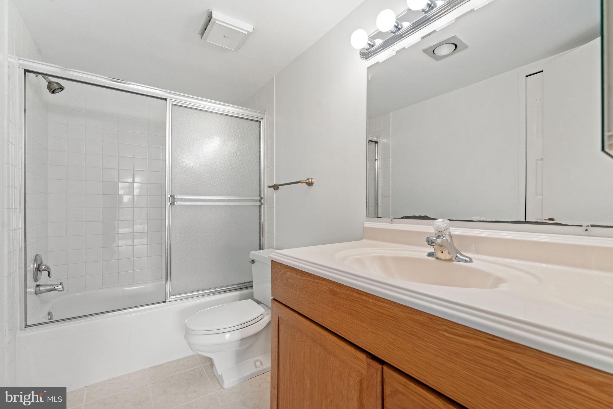 1800 Old Meadow Road, Unit 1218 McLean, VA 22102 - Photo 33 of 55 a bathroom with a sink a toilet and shower