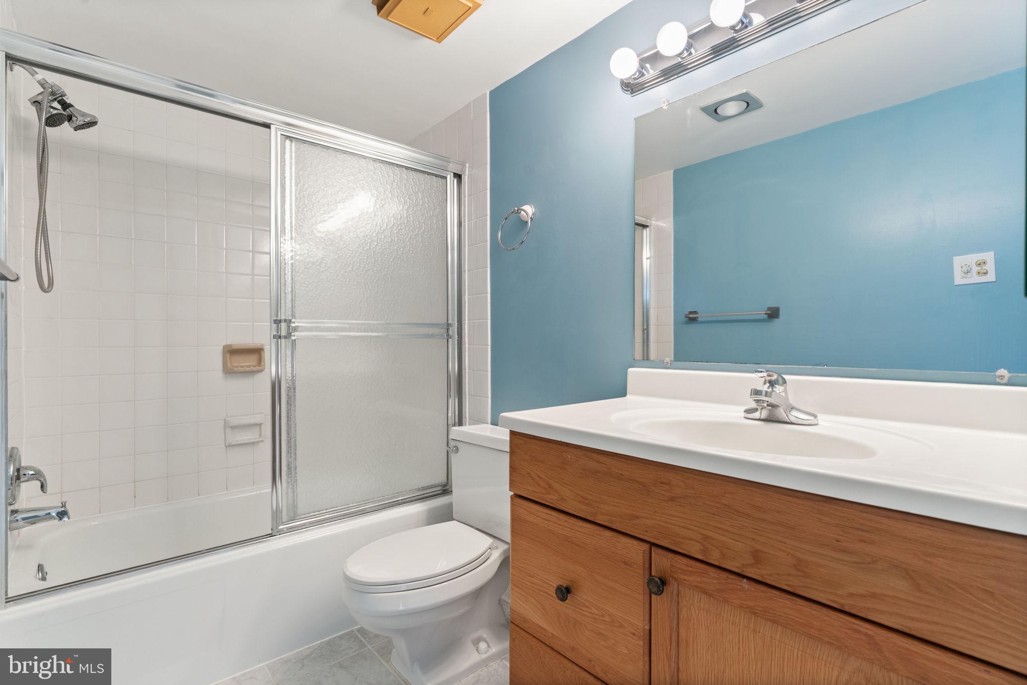 1800 Old Meadow Road, Unit 1218 McLean, VA 22102 - Photo 39 of 55 a bathroom with a sink a toilet and shower