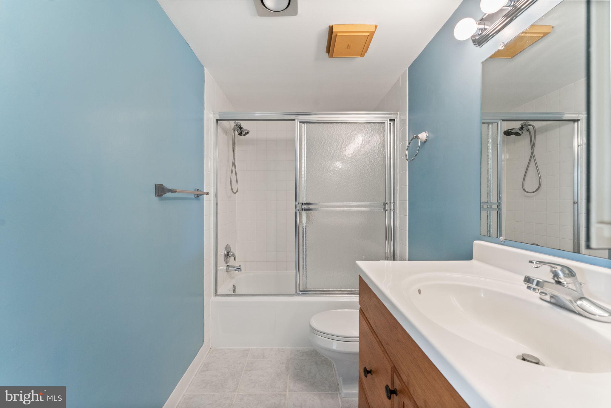 1800 Old Meadow Road, Unit 1218 McLean, VA 22102 - Photo 40 of 55 a bathroom with a sink a toilet and shower
