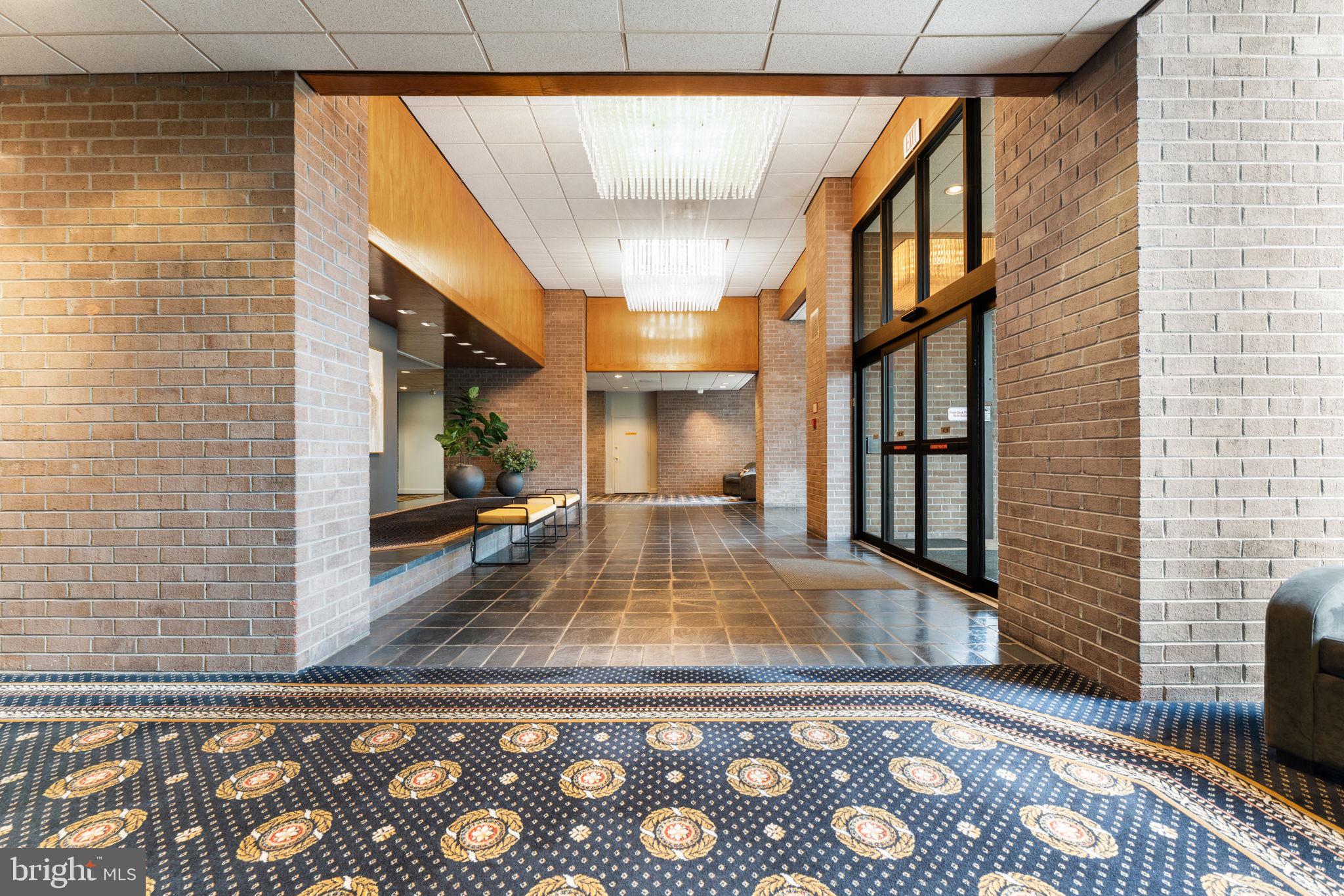 1800 Old Meadow Road, Unit 1218 McLean, VA 22102 - Photo 7 of 55 a view of a living room and hallway with wooden floor