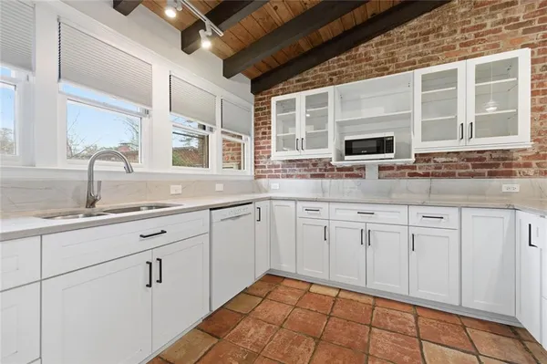 a kitchen with stainless steel appliances granite countertop a stove sink and cabinets