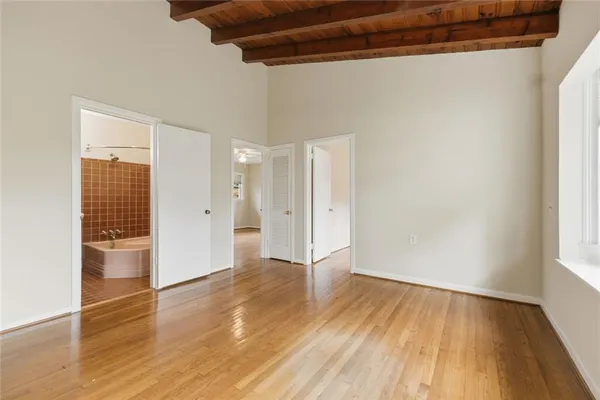 a view of an empty room with wooden floor