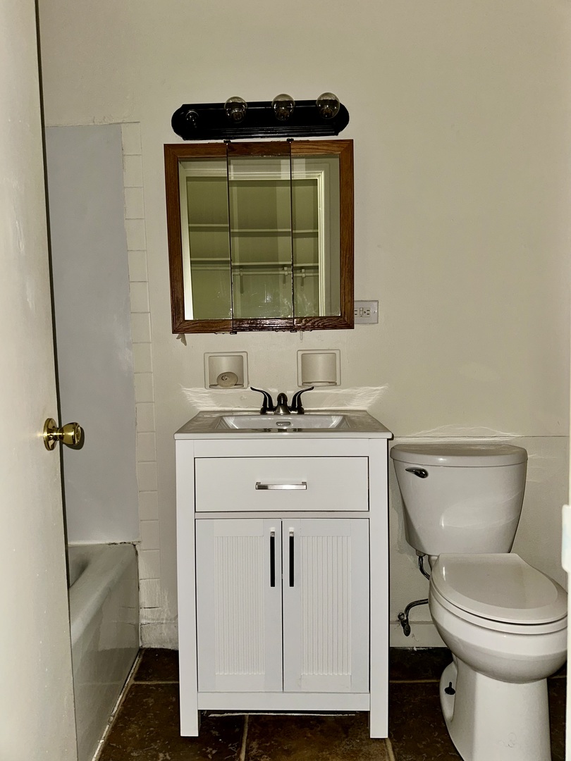 250 North Entrance Avenue, Unit 1B Kankakee, IL 60901 - Photo 4 of 6 a bathroom with a toilet sink and mirror