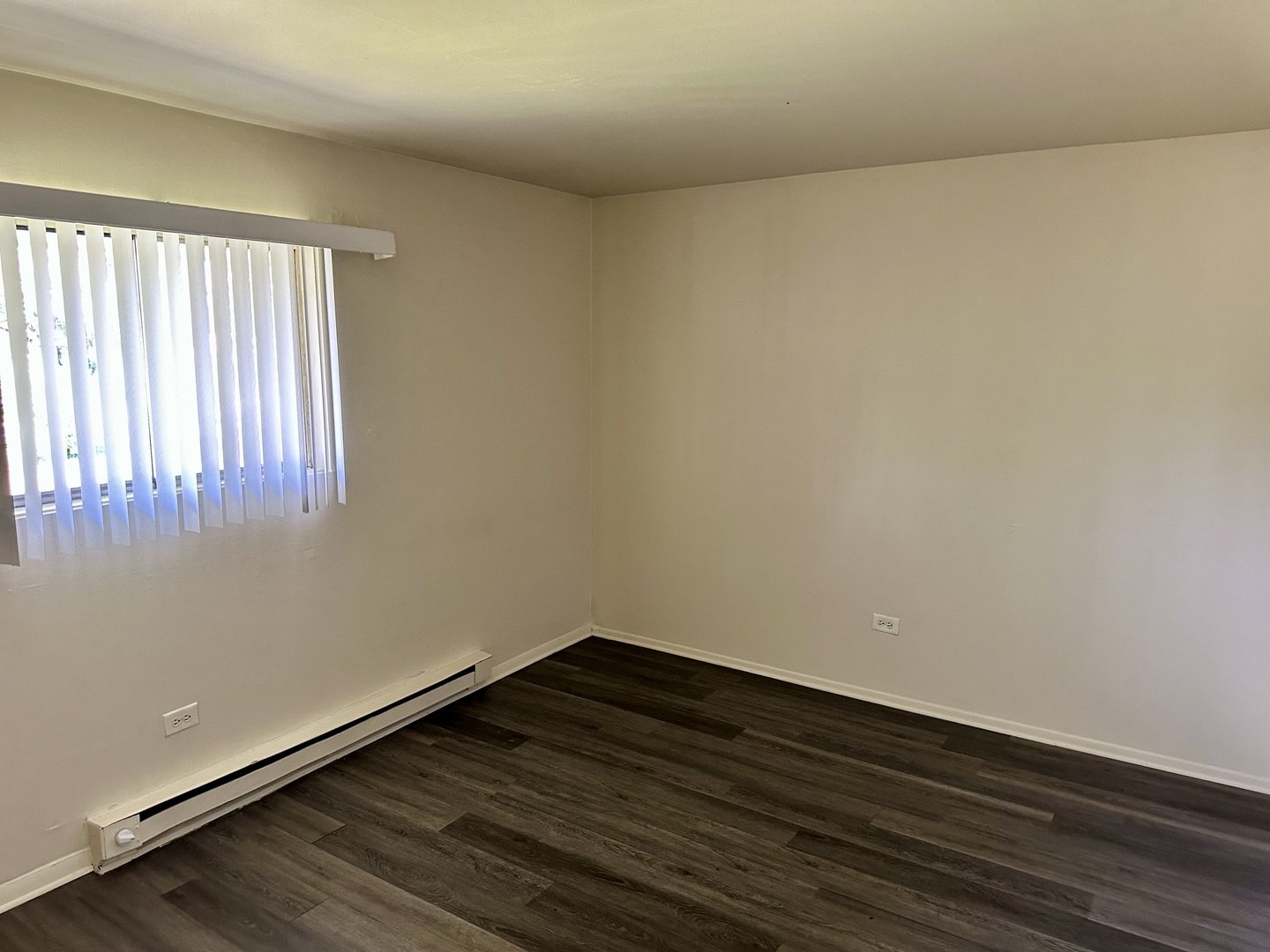 250 North Entrance Avenue, Unit 1B Kankakee, IL 60901 - Photo 5 of 6 a view of an empty room with wooden floor and a window