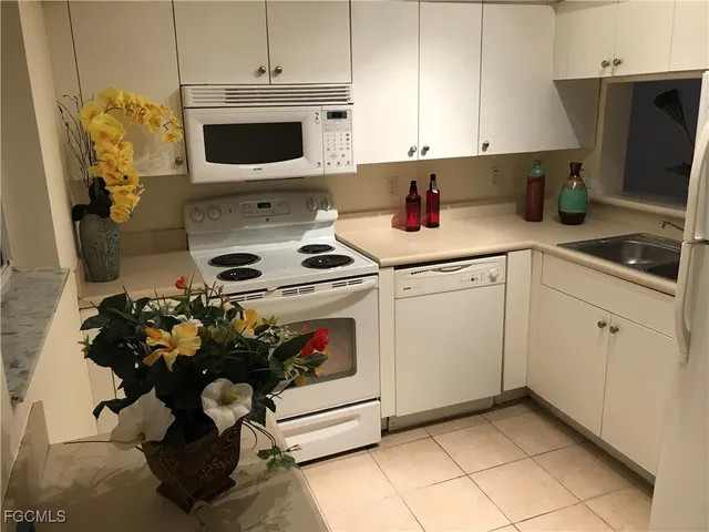 a kitchen with a sink a stove and cabinets