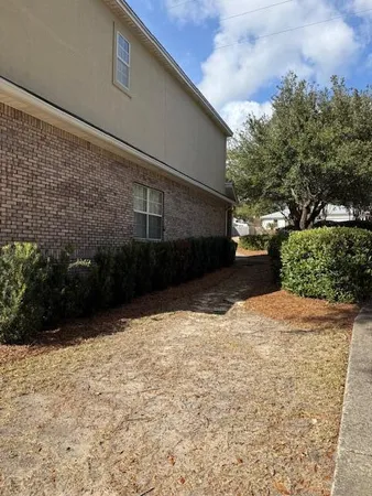 a view of garage with green space
