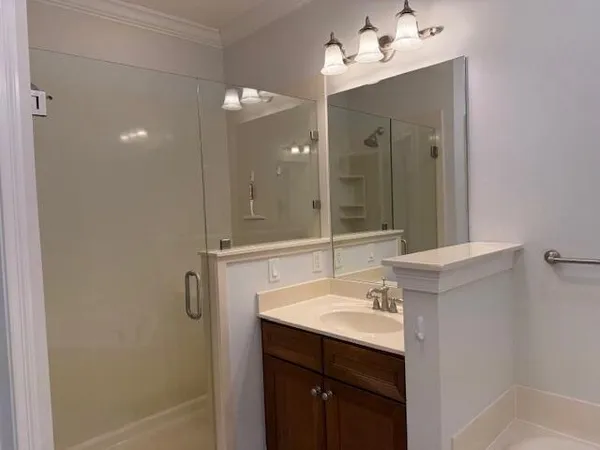 a bathroom with a sink vanity and mirror