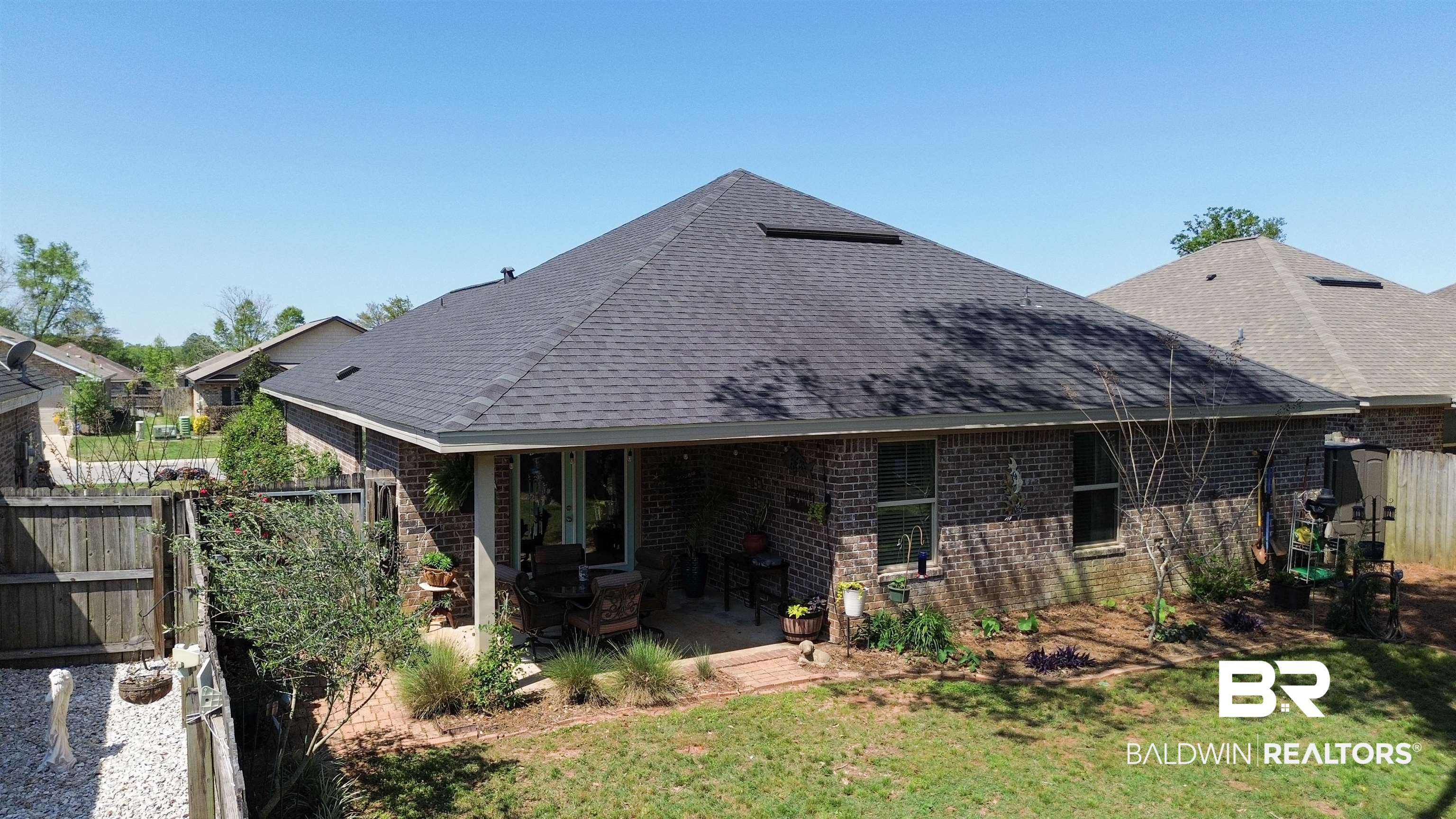 1304 Majesty Loop Foley, AL 36535 - Photo 37 of 44 Rear view of property with a fenced backyard, a patio, roof with shingles, and brick siding