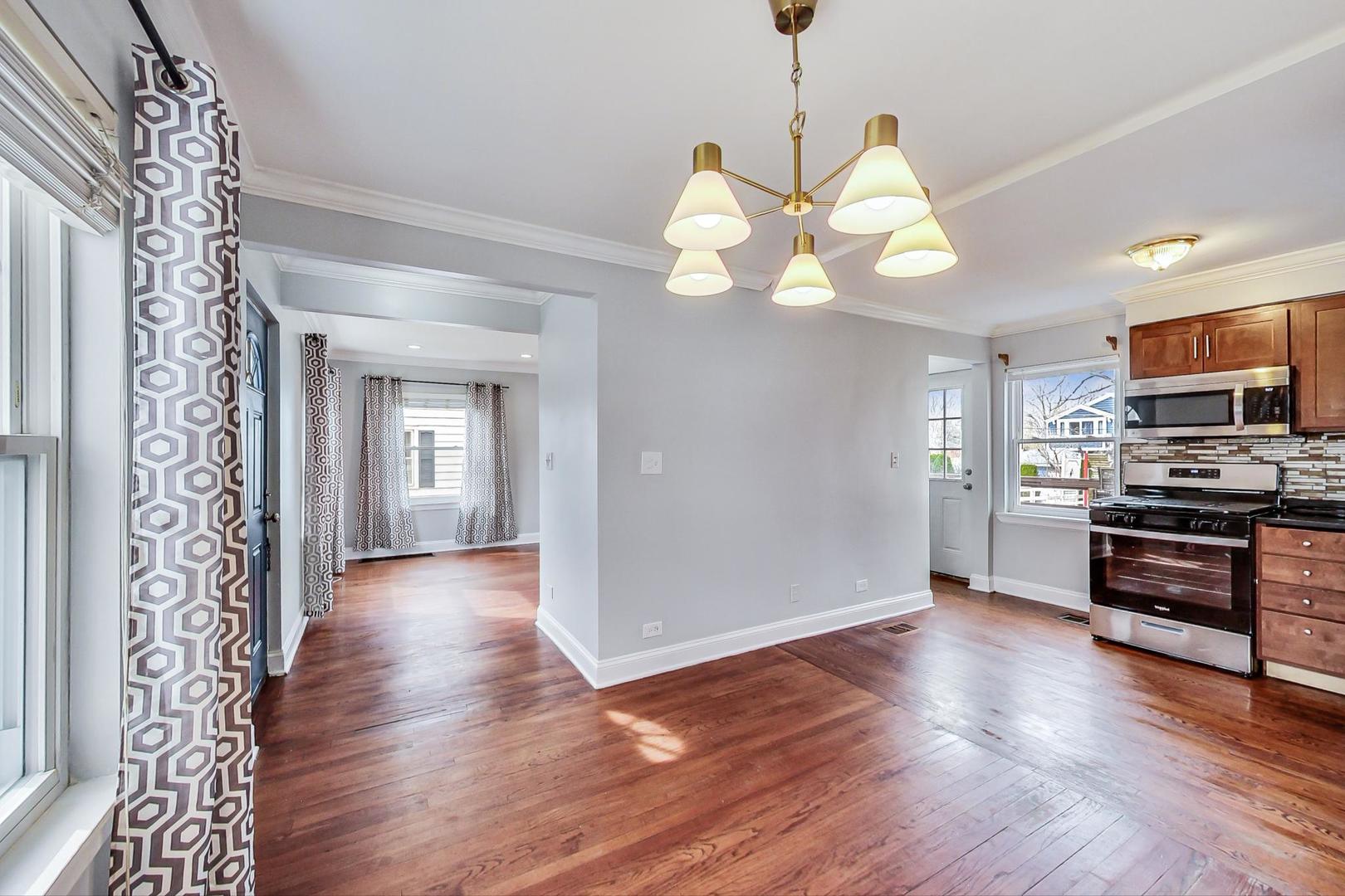 402 North Main Street Mount Prospect, IL 60056 - Photo 5 of 19 a view of a kitchen with a stove wooden cabinet wooden floor and a chandelier