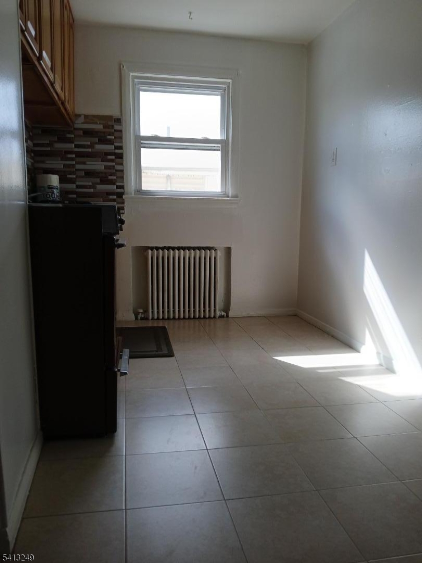 97 Main Avenue, Unit 2 Passaic, NJ 07055 - Photo 3 of 10 a view of an empty room with a window