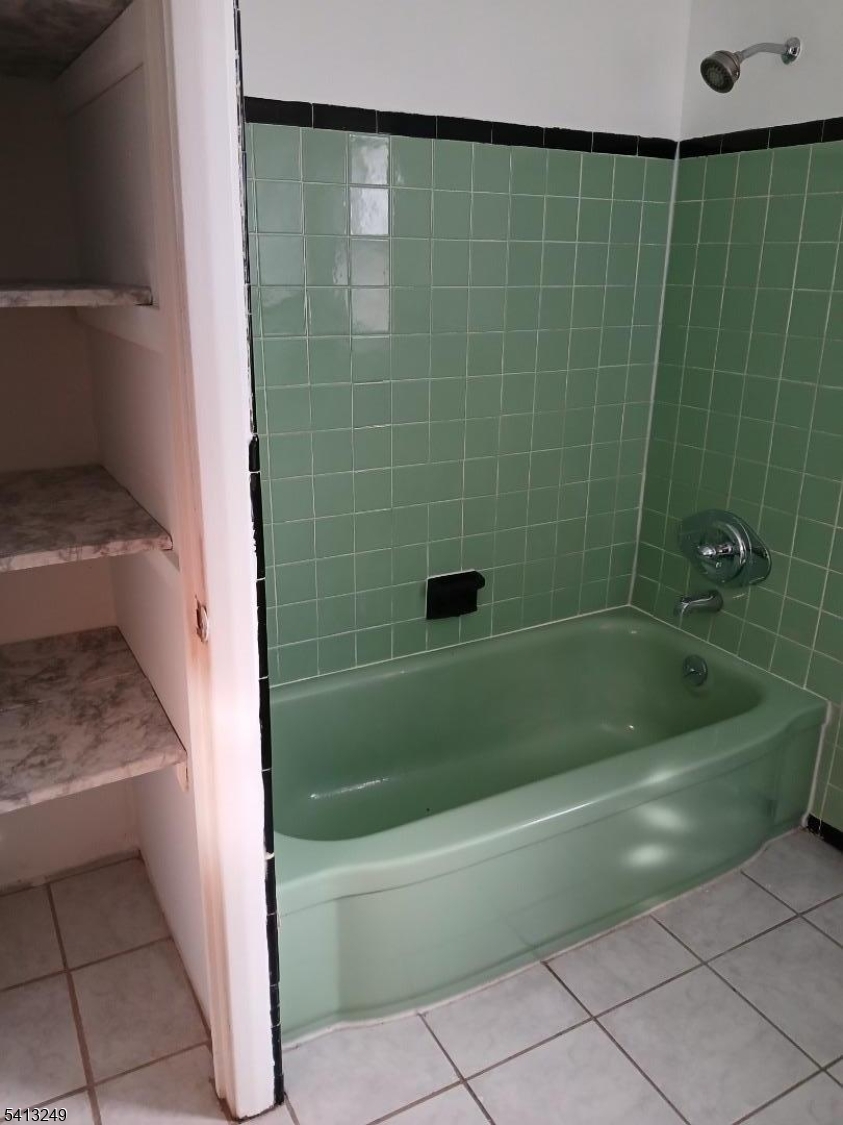 97 Main Avenue, Unit 2 Passaic, NJ 07055 - Photo 7 of 10 a bathroom with a shower and a bathtub