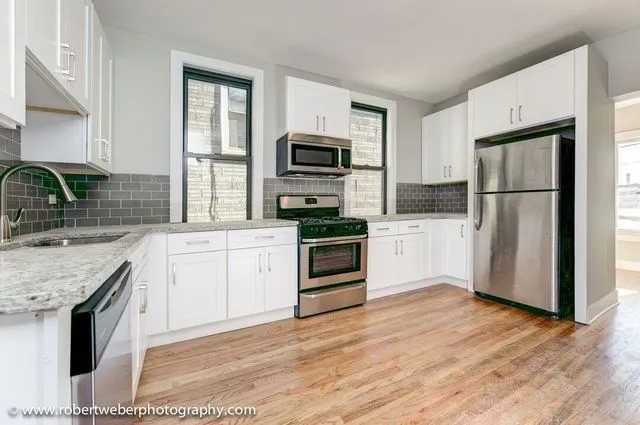 a kitchen with a refrigerator stove and sink