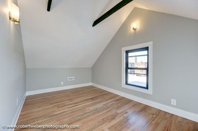 1363 West Walton Street Chicago, IL 60642 - Photo 6 of 13 an empty room with wooden floor and windows