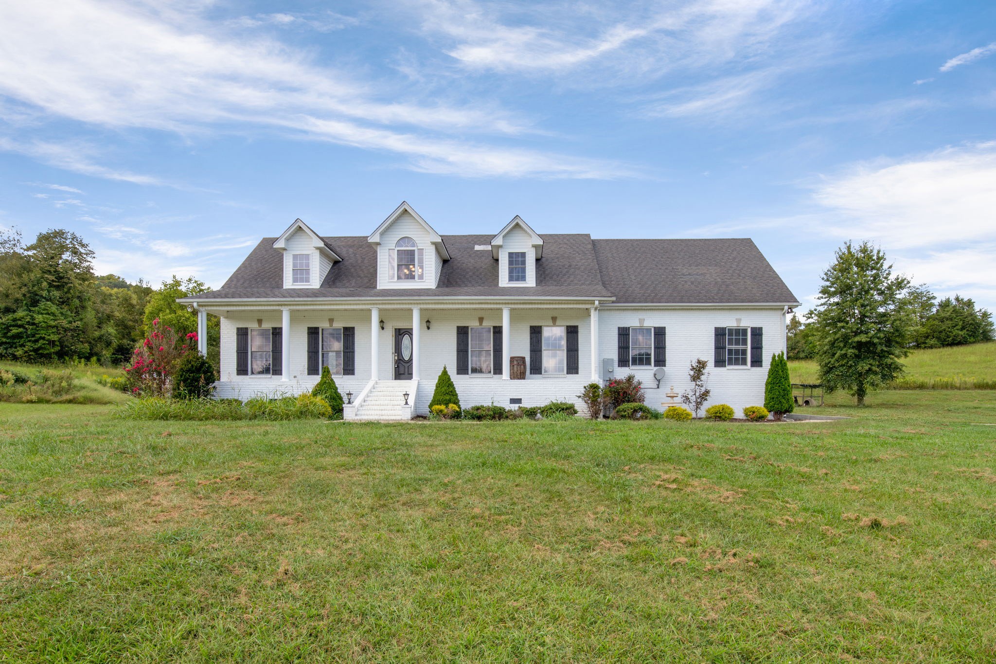 6697 Greenvale Road Watertown, TN 37184 - Photo 1 of 36 a front view of a house with a garden