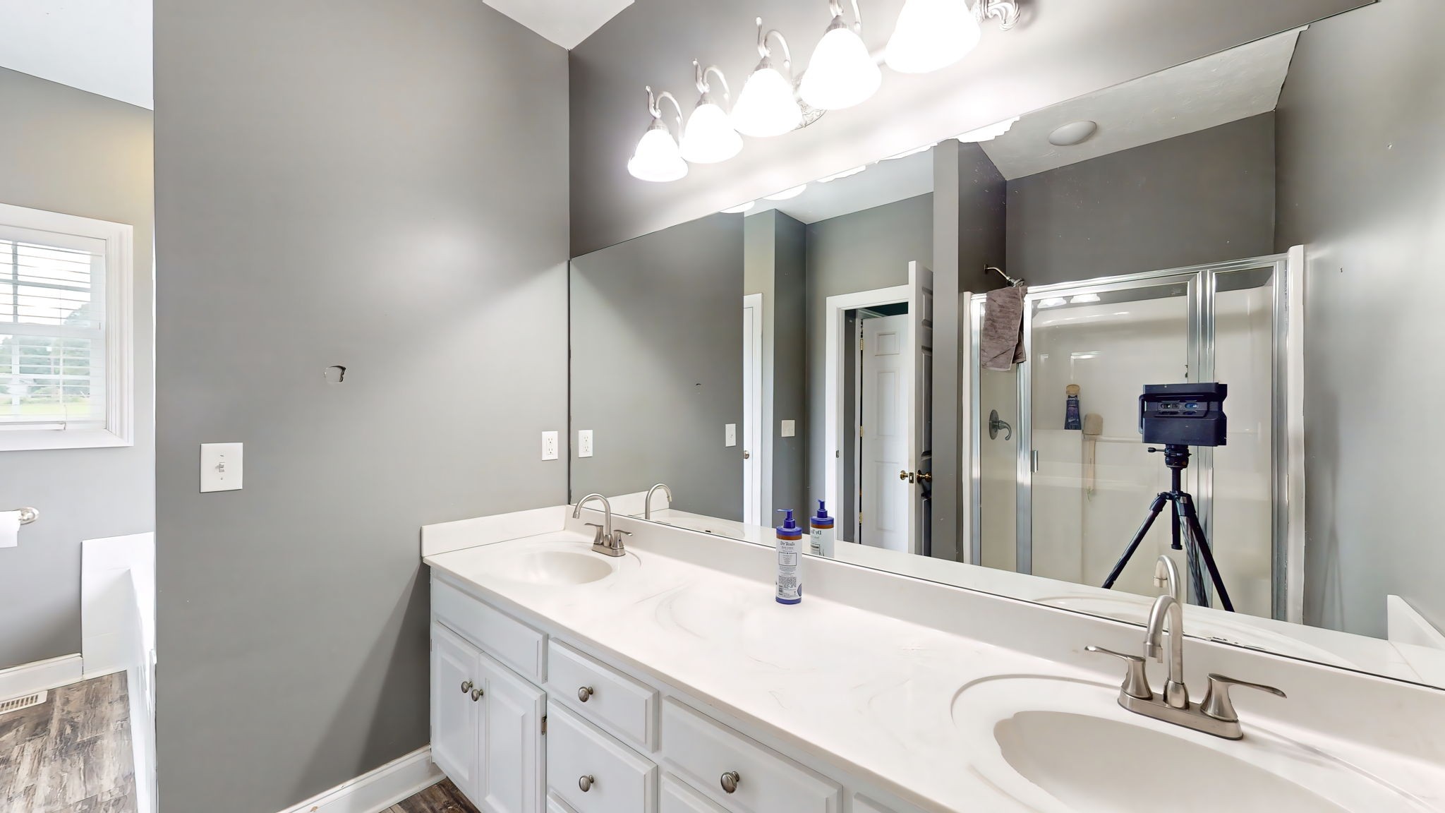 6697 Greenvale Road Watertown, TN 37184 - Photo 16 of 36 a bathroom with a double vanity sink and a mirror