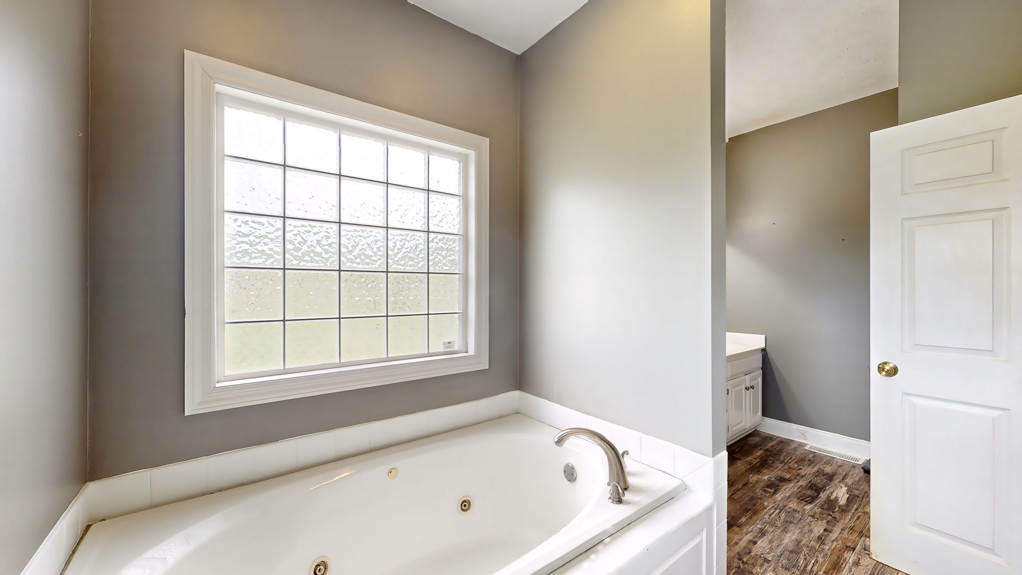 6697 Greenvale Road Watertown, TN 37184 - Photo 17 of 36 a bathroom with a tub and a window