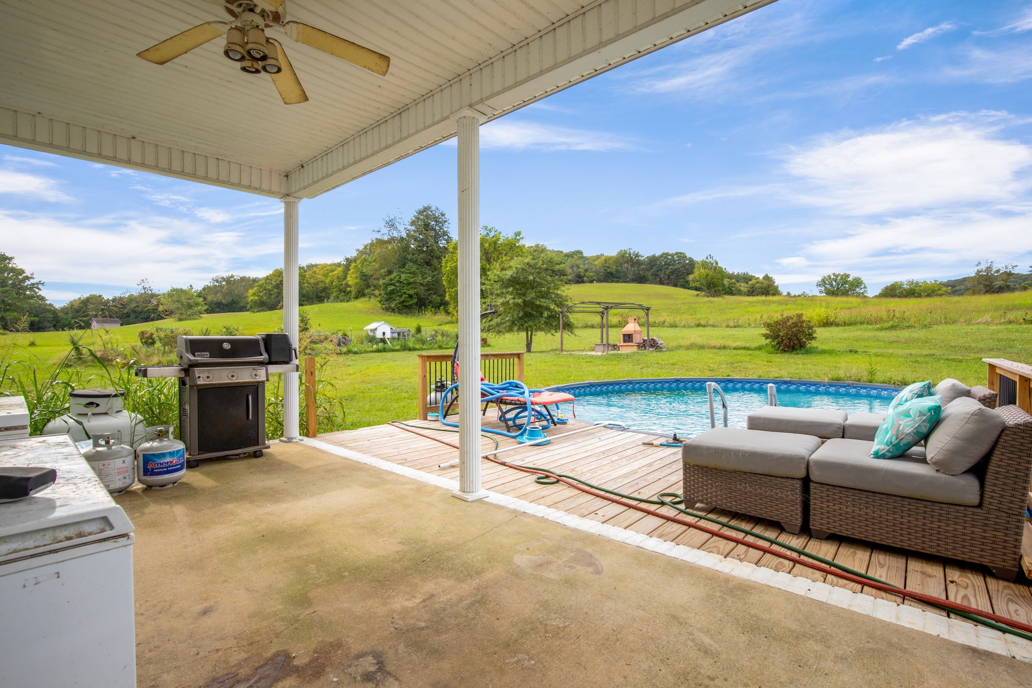 6697 Greenvale Road Watertown, TN 37184 - Photo 29 of 36 a view of a patio with a table chairs under an umbrella