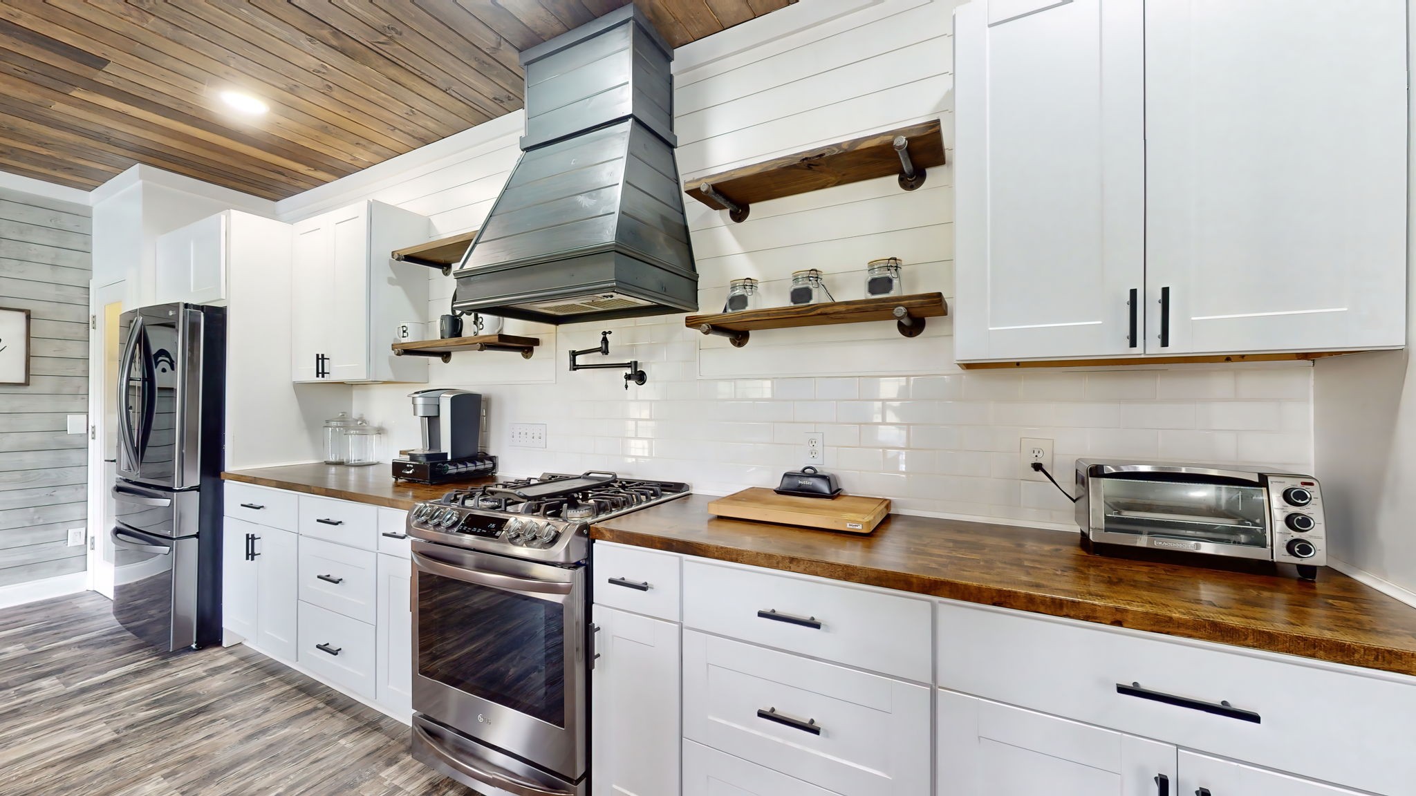 6697 Greenvale Road Watertown, TN 37184 - Photo 6 of 36 a kitchen with stainless steel appliances granite countertop a sink a stove and cabinets