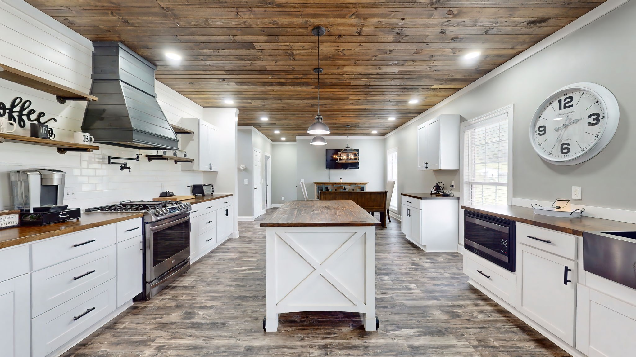 6697 Greenvale Road Watertown, TN 37184 - Photo 8 of 36 a large kitchen with stainless steel appliances granite countertop a large stove a sink dishwasher and white cabinets with wooden floor