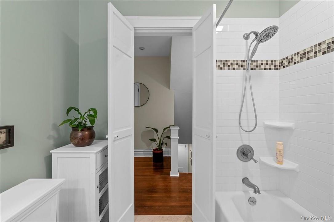 28 Inningwood Road Ossining, NY 10562 - Photo 22 of 37 Bathroom with tiled shower / bath and hardwood / wood-style flooring