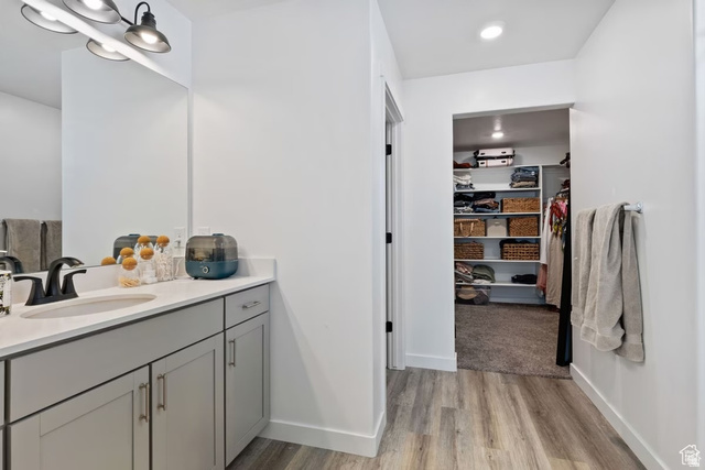 1323 South Raintree Lane Santaquin, UT 84655 - Photo 12 of 23 Bathroom with vanity, a walk in closet, light wood-type flooring, and recessed lighting