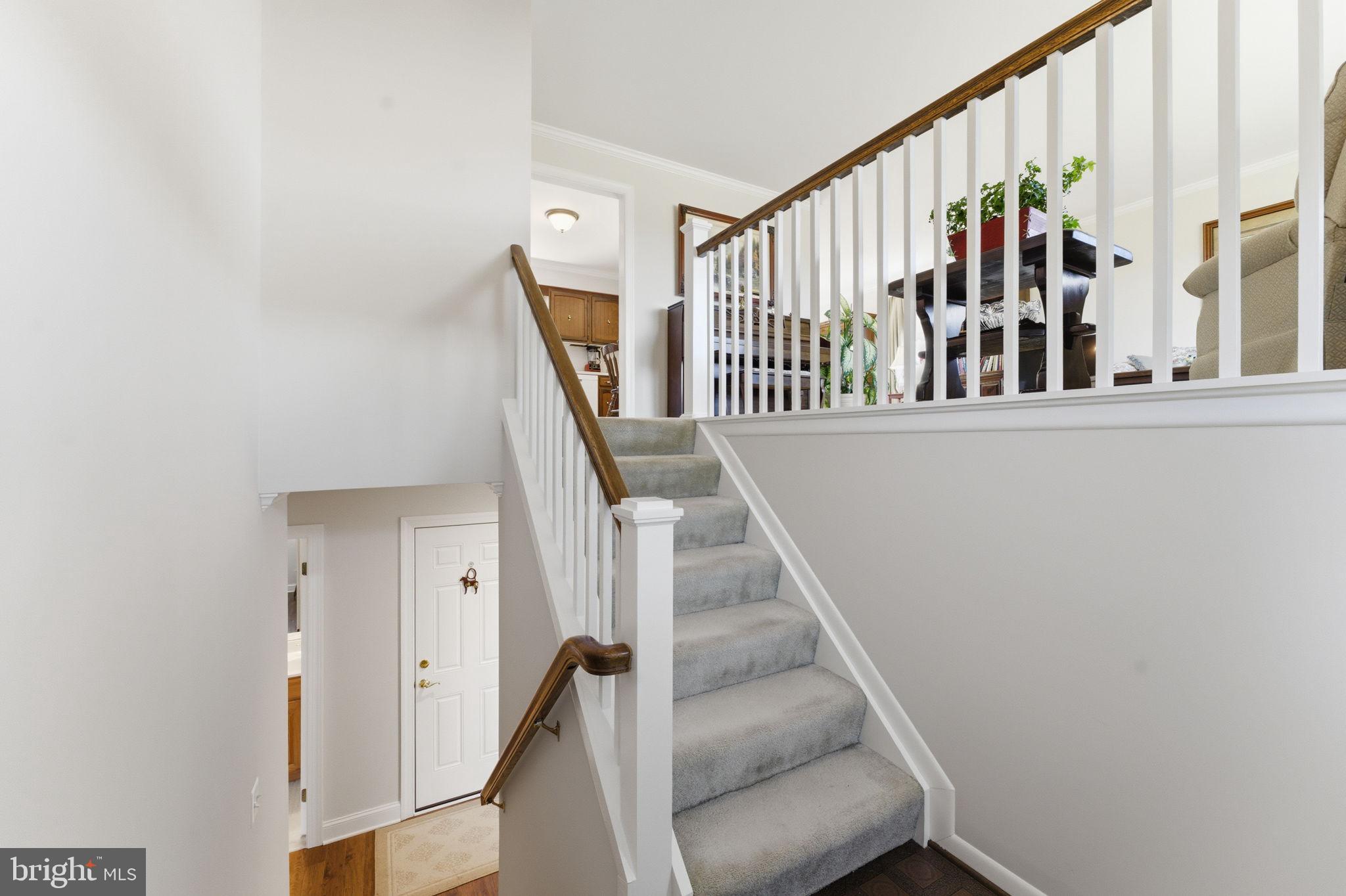 6163 Georgetown Road Broad Run, VA 20137 - Photo 36 of 94 a view of staircase with lots of frames on wall and a window