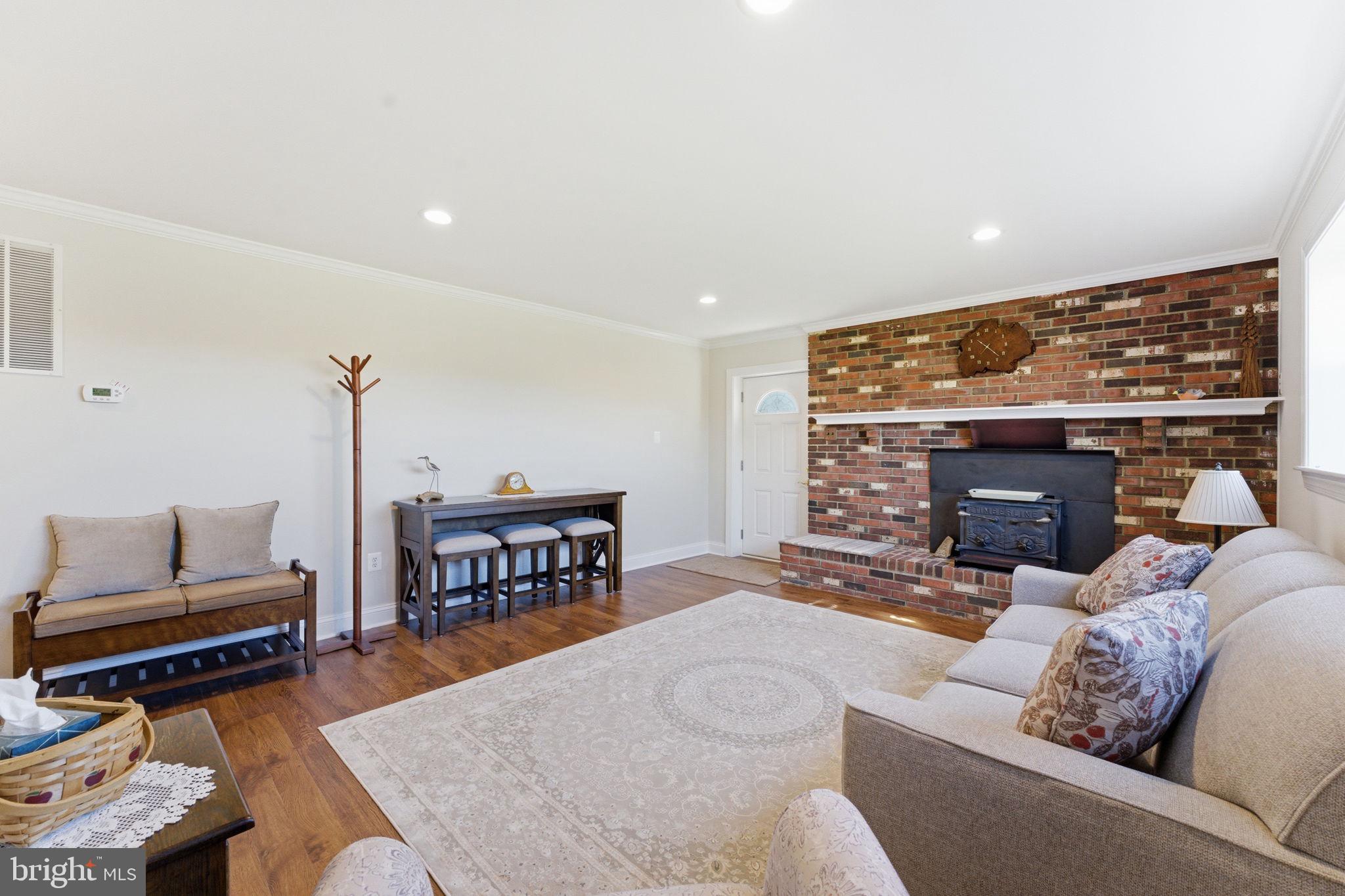 6163 Georgetown Road Broad Run, VA 20137 - Photo 38 of 94 a living room with furniture a fireplace and a flat screen tv